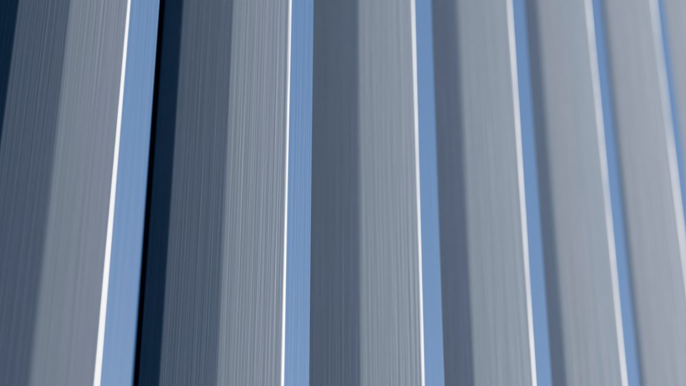 Close-up showing vertical blue, gray, and white fabric stripes with visible texture and folds under soft light.