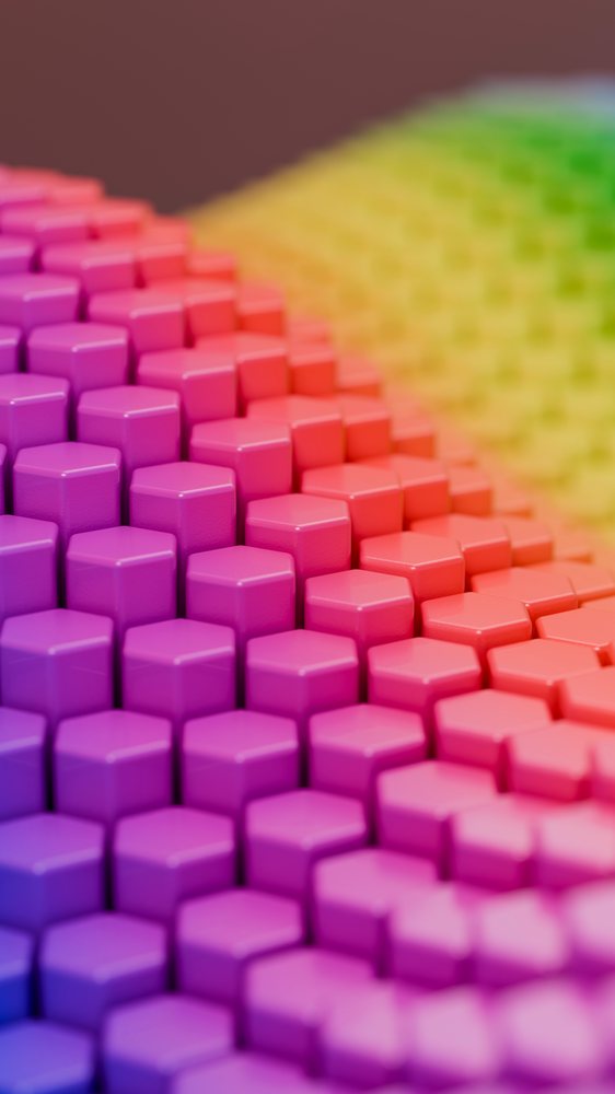 3D hexagonal cubes with smooth, shiny surfaces arranged in a gradient pattern spanning purple to green in an abstract digital illustration.