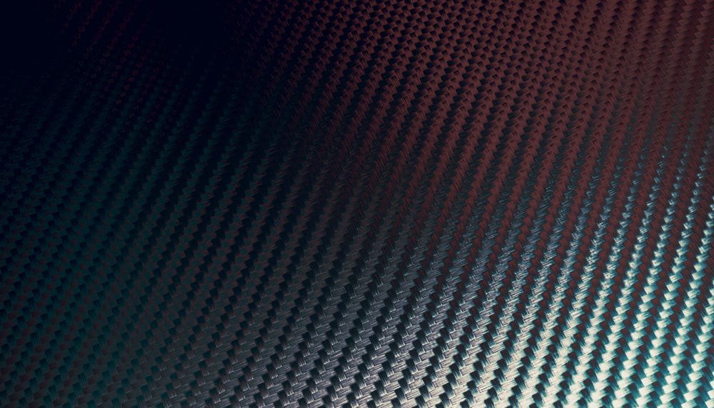 Close-up view of dark carbon fiber weave texture showing the intricate patterned surface.