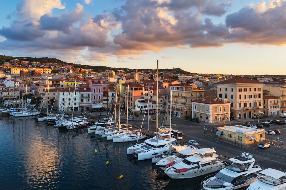 Harbour at Dawn with sailboats and yachts moored along the waterfront, Travel Images, La Maddalena, Sardinia, Italy.