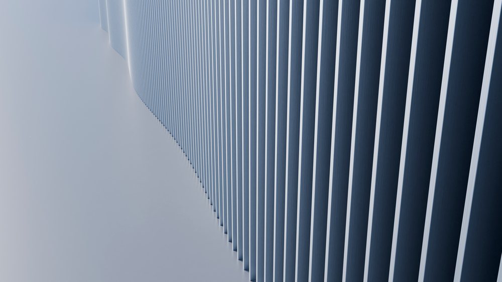 Close-up of a blue wall showing vertical lines with repetitive patterns and shadows in modern architectural design.