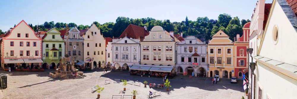 Historic town square with fountain and outdoor seating, Bohemia, Czech Republic.