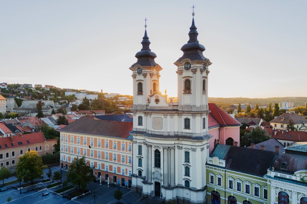 The Minorite Church with twin towers at Dobó Square during Sunrise under early morning light, Cityscape, Eger, Hungary.