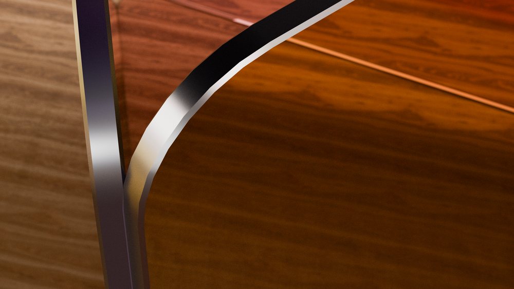 Close-up of a transparent glass edge resting on a polished brown wood table surface showcasing natural wood grain texture and light reflection.