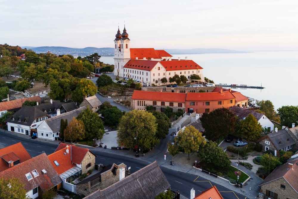 Benedictine Abbey of Tihany with red roofs and twin towers overlooks Lake Balaton at Dawn, Cityscapes, Hungary.