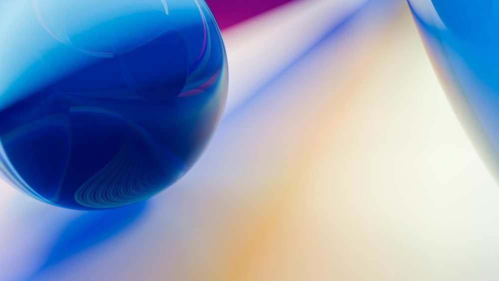 Abstract digital illustration of blue glass spheres with colorful reflections on a smooth gradient background.