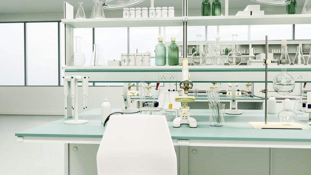 Laboratory workspace with microscope, pipettes, glassware, and scientific equipment on clean benches under large windows.