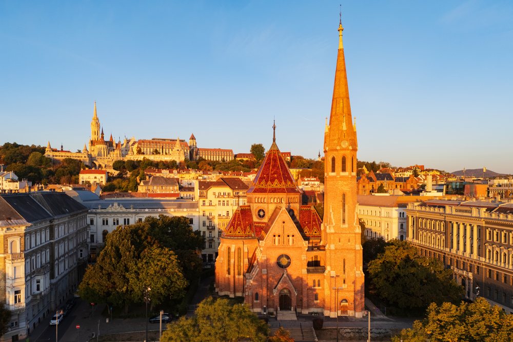 Szilágyi Dezso Square Reformed Church with tall spire illuminated by morning sunlight, Landscape, Budapest, Hungary.
