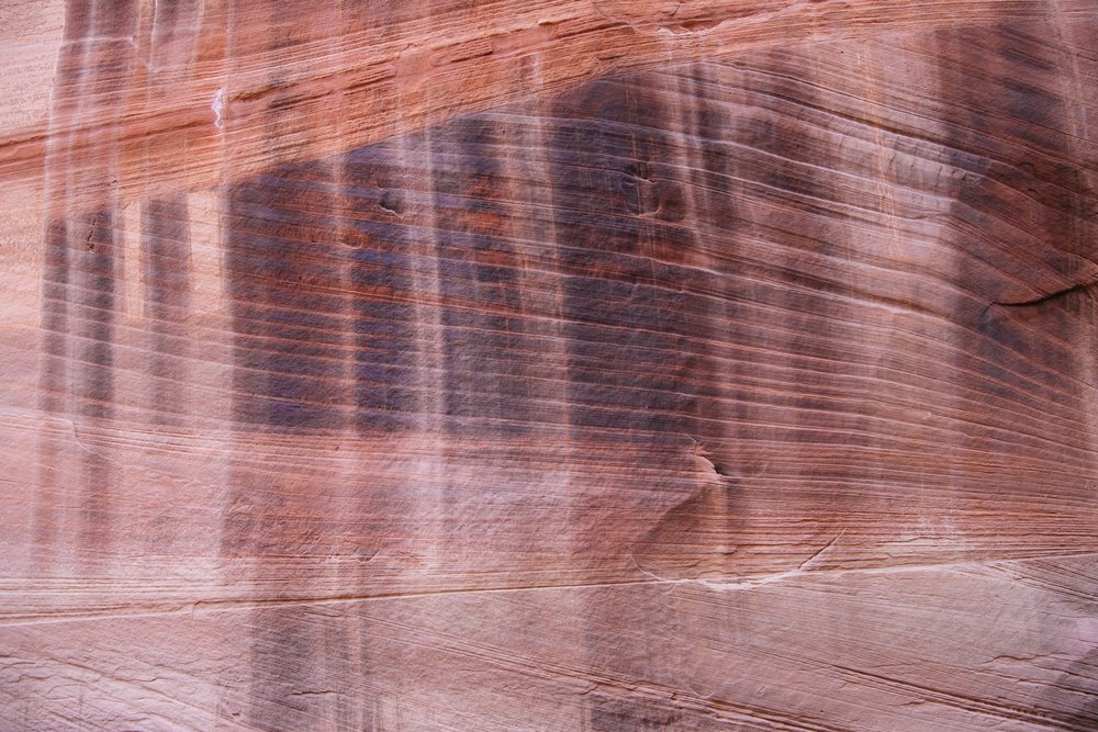 Buckskin Gulch slot canyon features layered sandstone rock formations with striped geologic strata, Utah, USA.