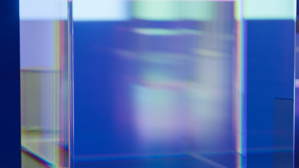 Abstract colorful translucent glass shapes with geometric forms and gradient light reflections in a modern design.