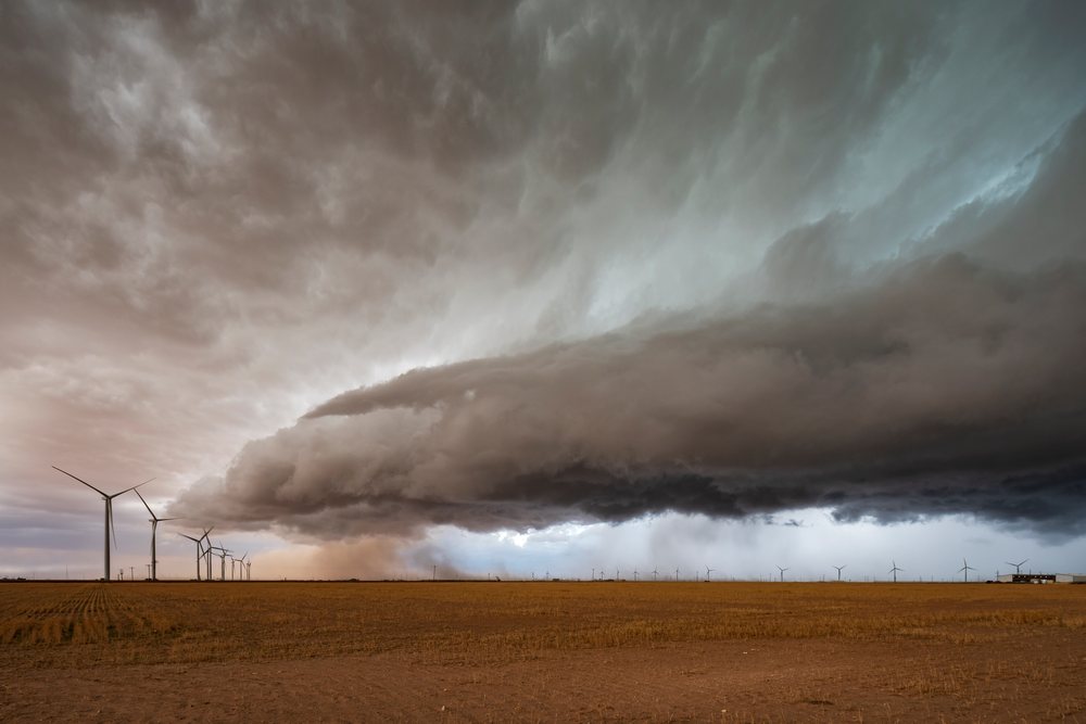 Supercell storm with dark clouds moves over a wind farm in the Great Plains, Garden City, Texas, USA.