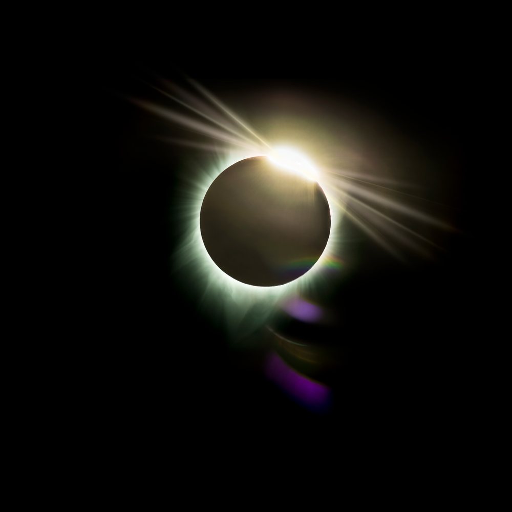 Solar eclipse with diamond ring effect and sun corona visible against the black sky over, Los Angeles, USA.