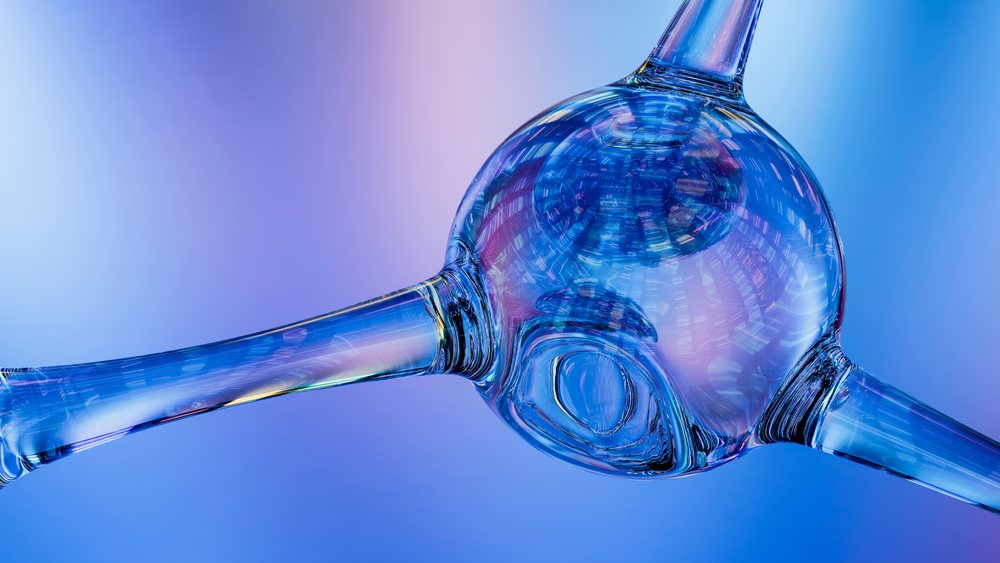 Close-up of a glass molecular ball and stick model illuminated with blue and purple lighting on a gradient background.