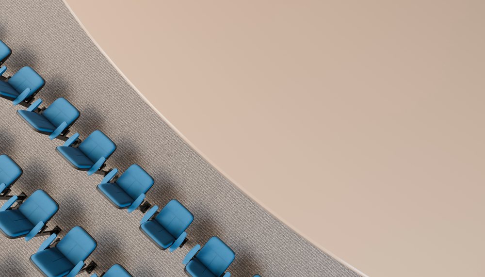 Blue chairs with armrests arranged in rows inside a modern conference room.