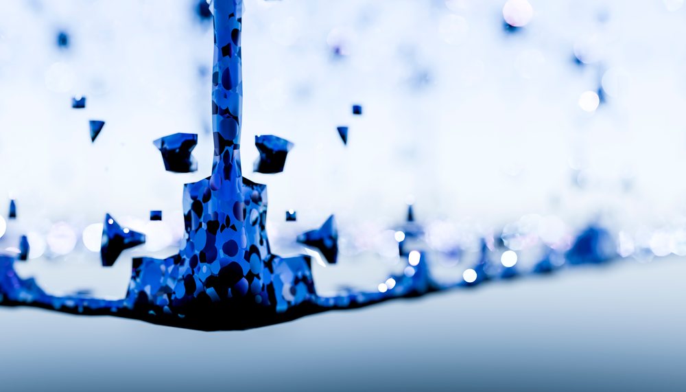 Close-up of a blue-toned water splash showing droplets and fluid motion in detail.
