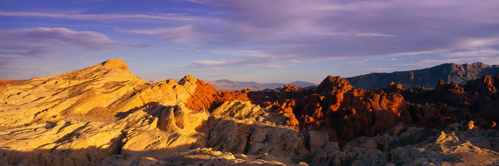 Scenic view of red sandstone rock formations and desert landscape with sunset light, Nevada, USA.