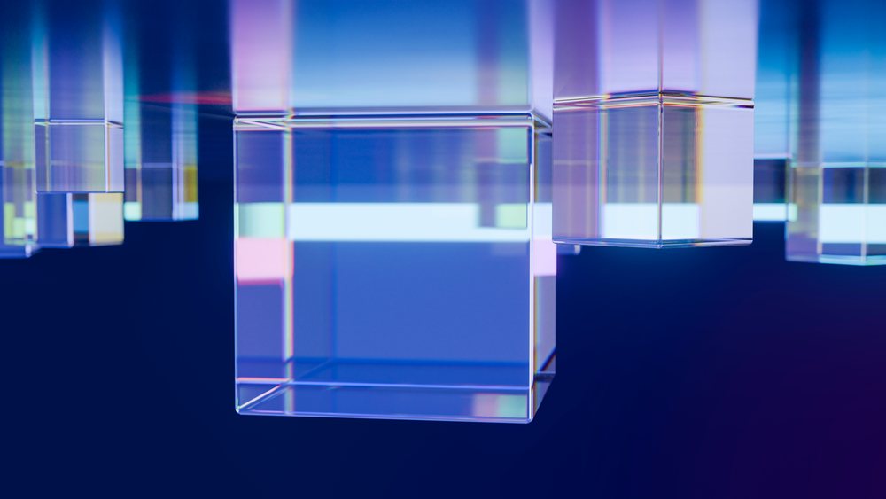 Multiple transparent glass cubes float above a blue gradient background in a 3D digital illustration showing reflection and refraction effects.