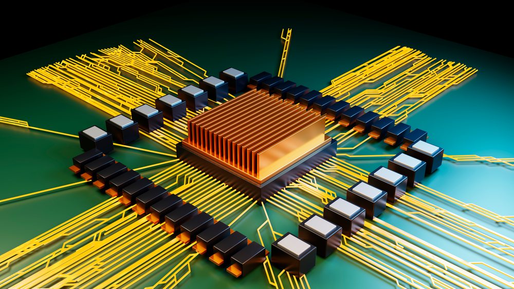 Computer chip with copper heat sink and gold wiring on green circuit board.