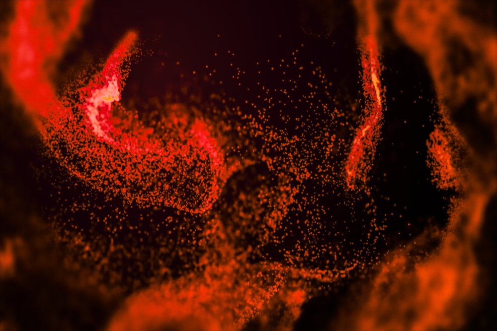 Red and orange glowing particles spread in an abstract dark space creating a dynamic energy effect.