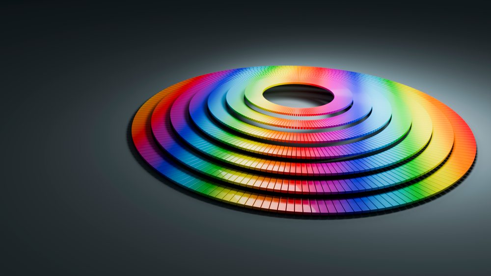 Multicolored blocks arranged in concentric circles with a vibrant rainbow color gradient in a 3D digital illustration.