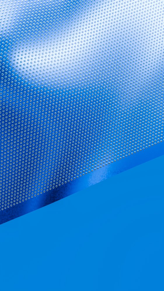 Shiny metal surface with uniform dotted pattern reflecting blue light.