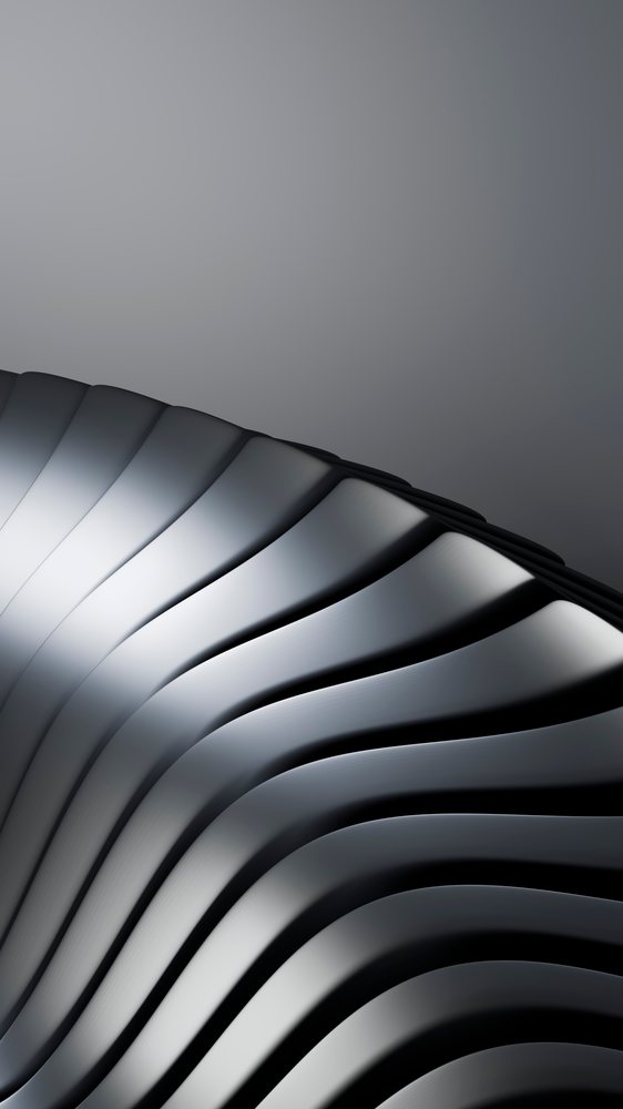 Close-up view of a shiny curved metallic surface.