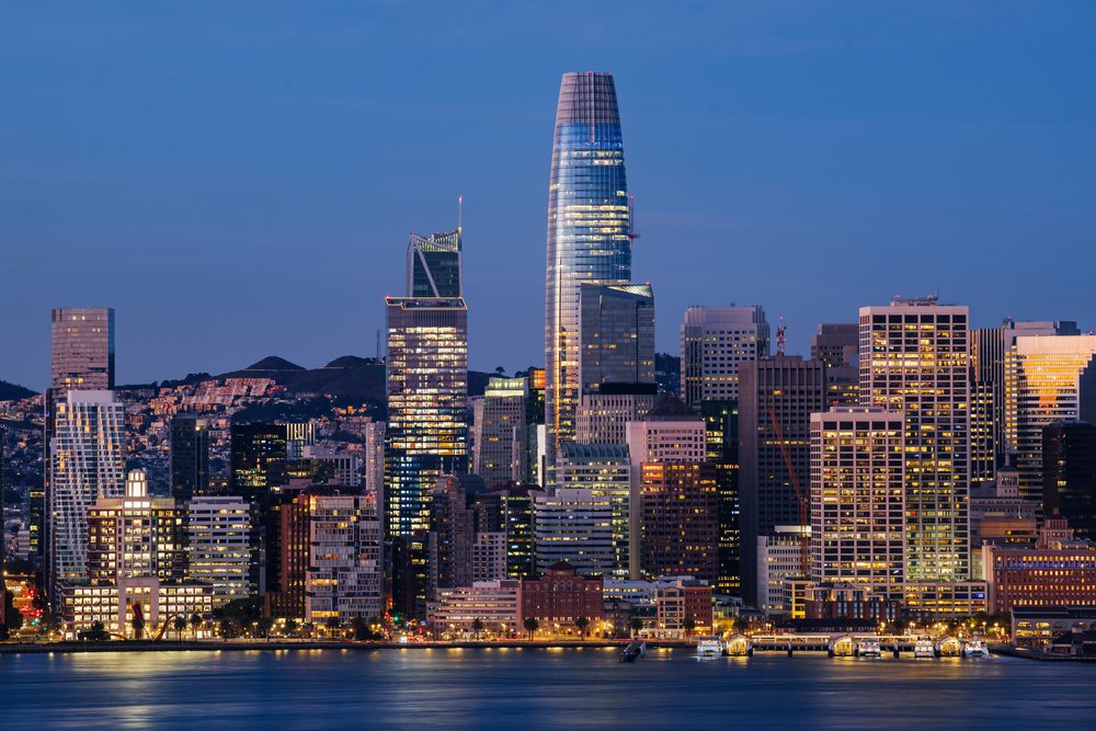 San Francisco skyline at Dawn with illuminated high-rise office buildings reflecting on the waterfront, City, Cityscapes, City Life, California, USA.