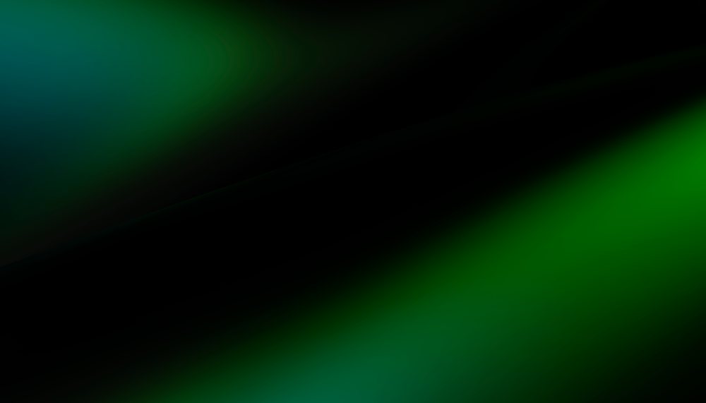 Abstract blurred gradient background featuring dark green, black, and blue tones with smooth color transitions.