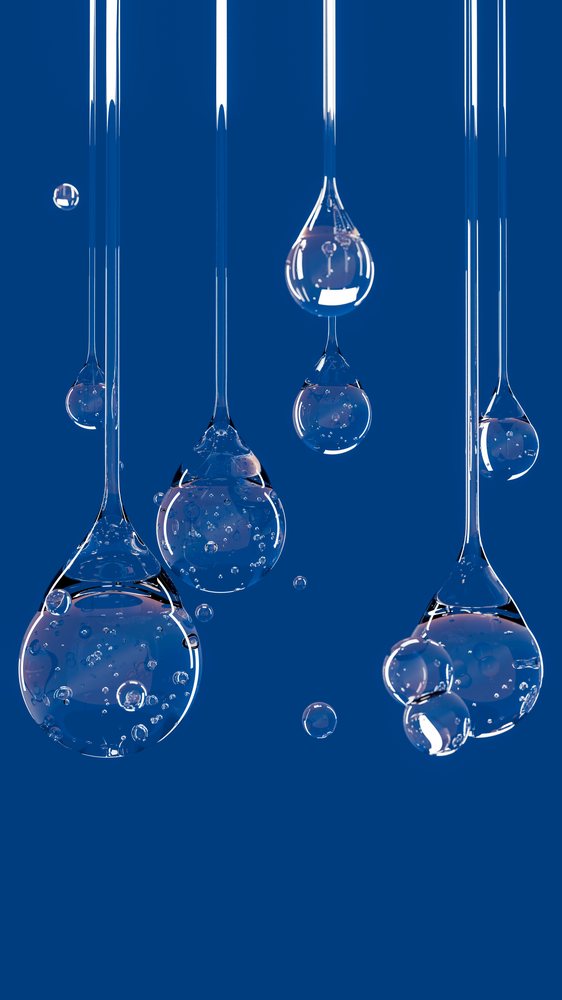 Multiple transparent liquid drops with bubbles are suspended against a solid blue background in an abstract arrangement.