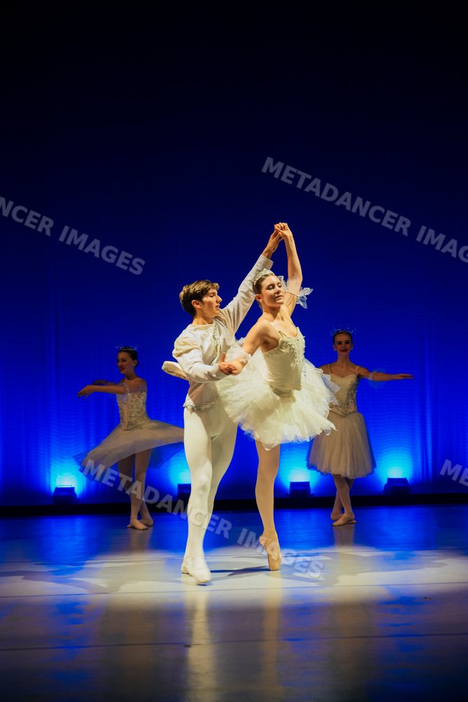 Ballet dancers performing a partnered dance during a holiday-themed