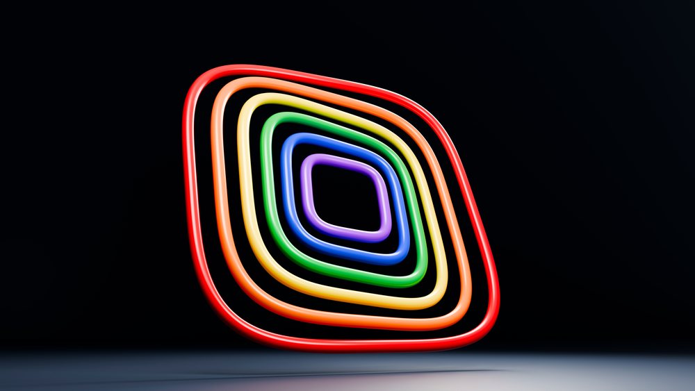 Glowing colorful concentric neon rings made of tubes displayed on a dark background in a modern artistic installation.
