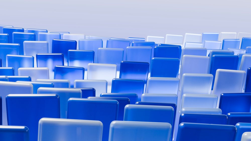 Rows of glossy blue glass rectangles arranged in a gradient geometric pattern against a light background.