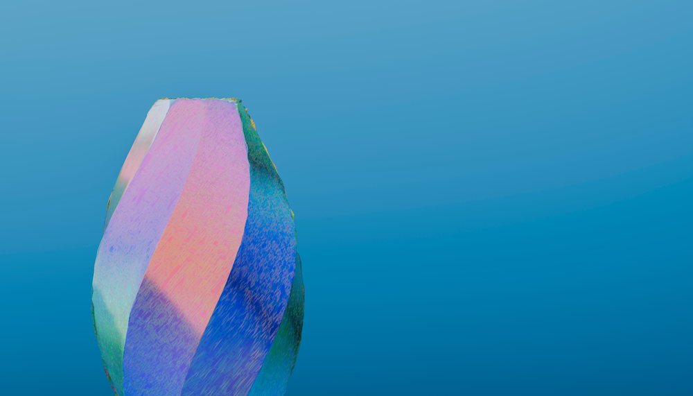 Iridescent polished stone with multicolor reflective surface on blue background.