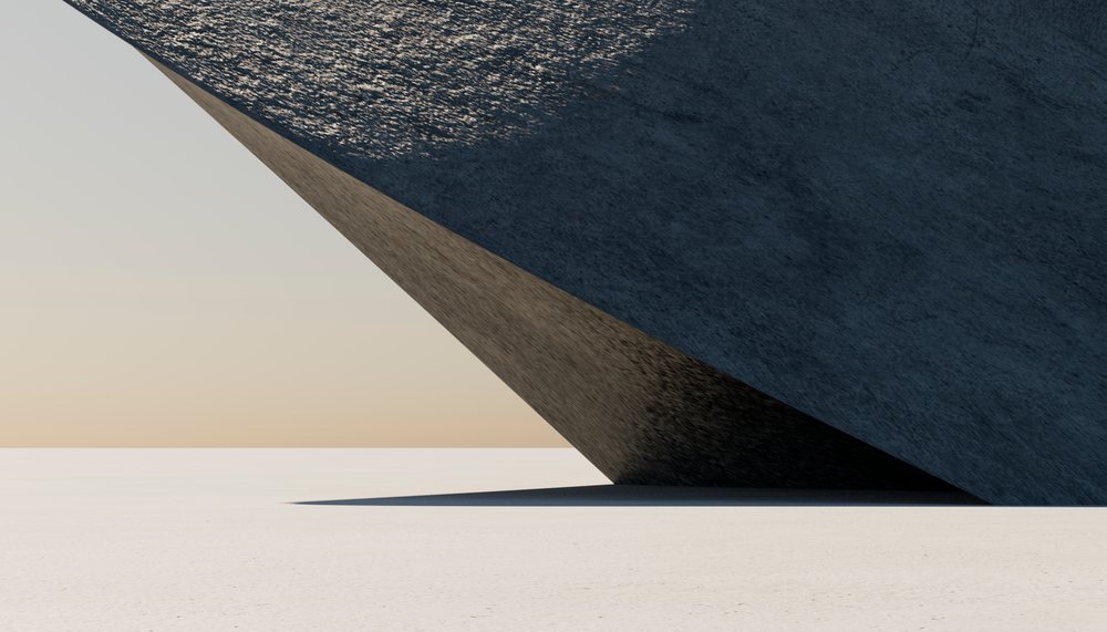 A large angular geometric structure casting shadows on desert sand
