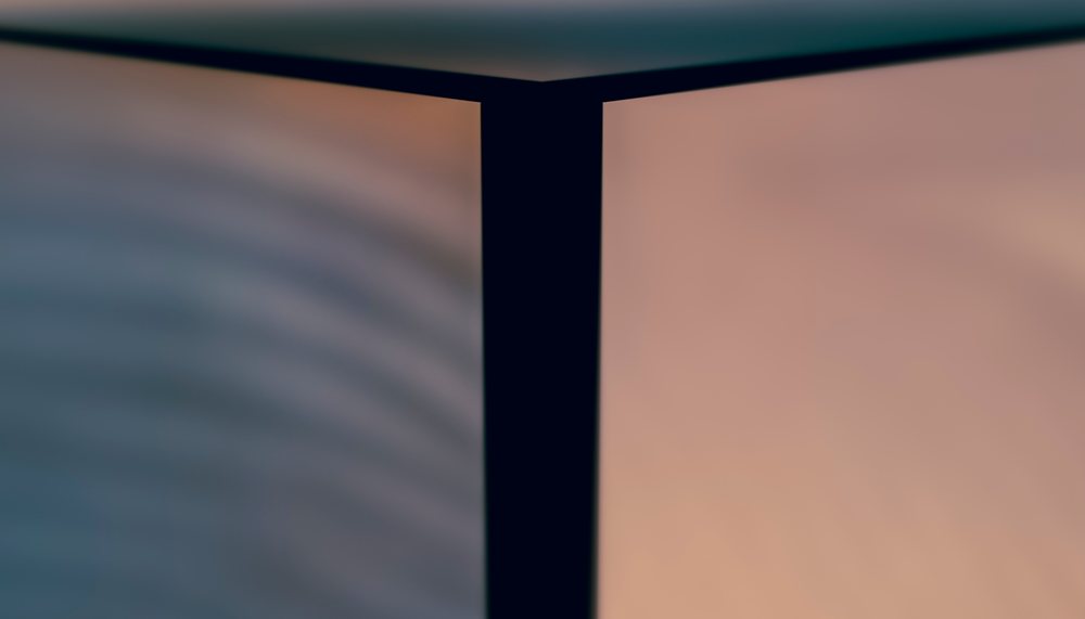 Close-up view of a softly lit modern interior corner where two walls meet.