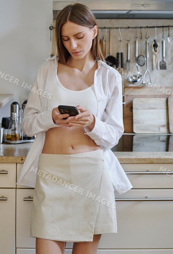 A white woman texts on her phone