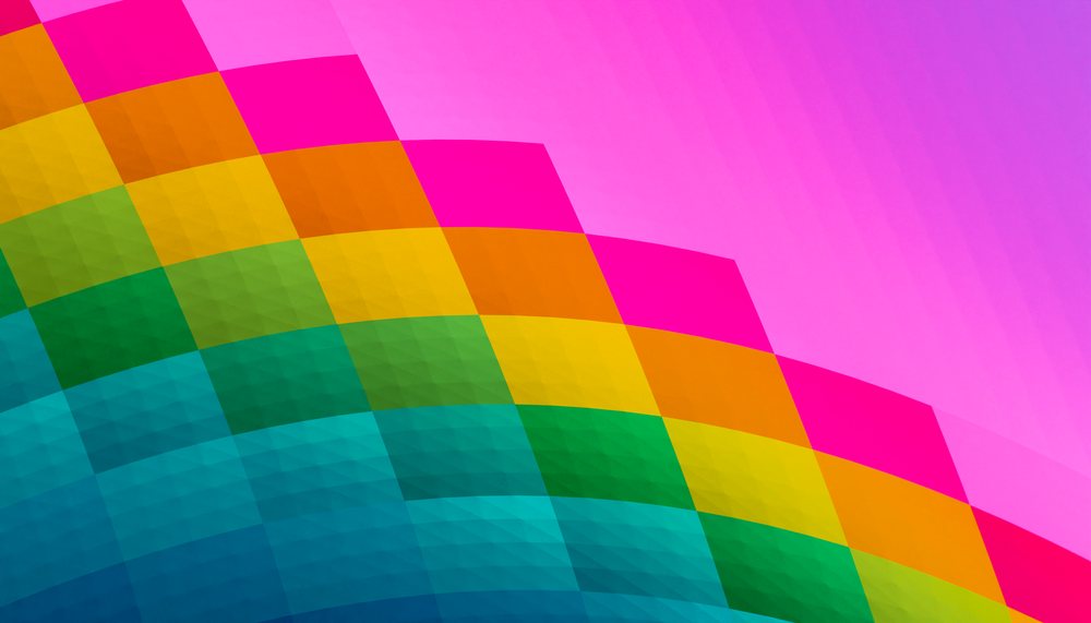 Close-up of a colorful geometric pattern with bright pink and rainbow colors forming an abstract curved design.