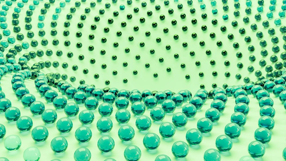 Blue glass marbles arranged in concentric circular patterns on a pale green surface in an abstract 3D illustration.