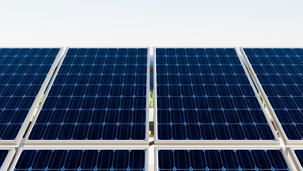 Solar panels arranged in a grid capture sunlight for renewable energy generation against a clear blue sky.