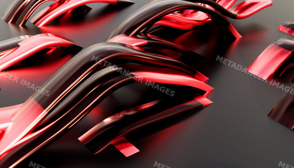 Close-up of curved shiny metal shapes reflecting red and black colors