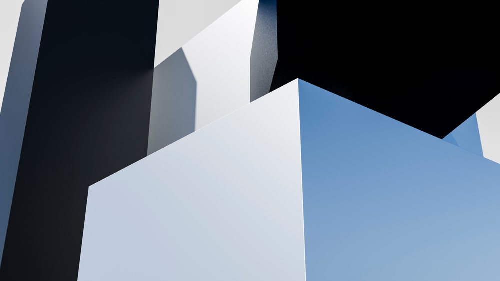 Abstract composition of black, white, and blue 3D geometric cube shapes with sharp angles and cast shadows.