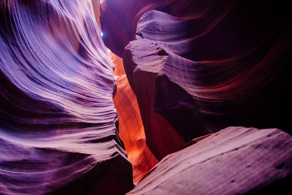 Beam of sunlight shines through a narrow opening in Antelope Canyon’s sculpted sandstone walls, Navajo Land, Arizona, USA.