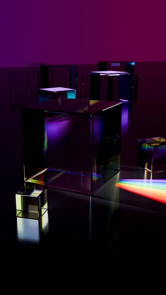 Multiple transparent glass cubes refract a rainbow spectrum on a dark reflective surface with a purple background.
