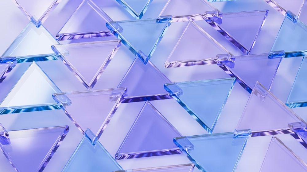 Overlapping transparent blue and purple glass triangles form a colorful abstract geometric pattern.