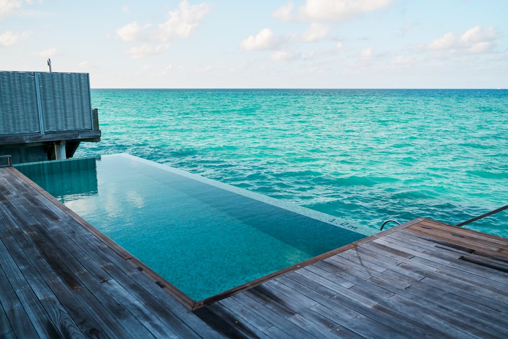 An infinity pool overlooks the turquoise ocean