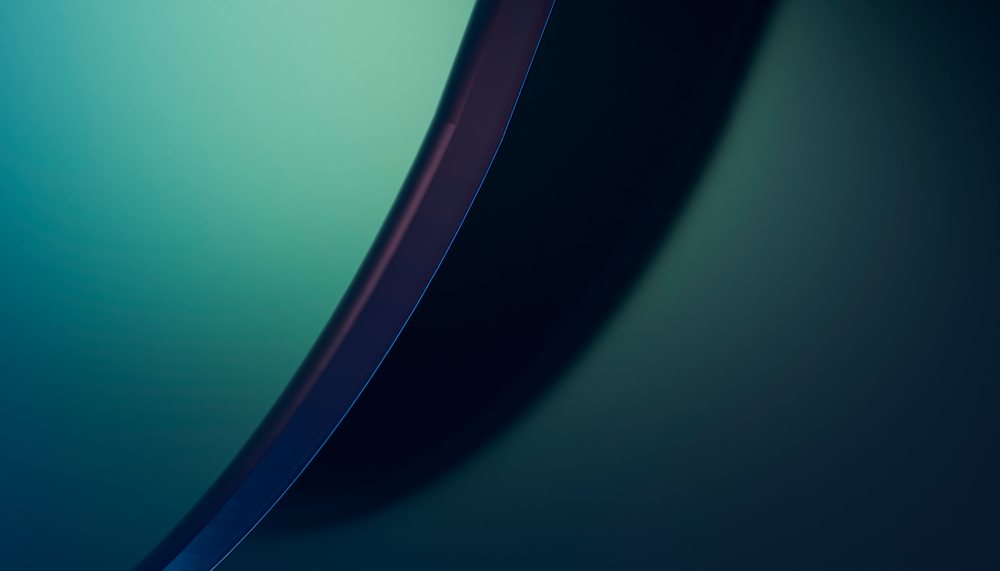 Digital artwork of smooth curved blue and green shapes flowing over a gradient background with elegant lines.