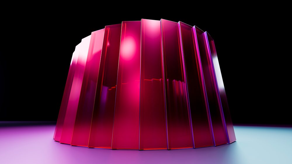 Red molded gelatin dessert with glossy translucent layers displayed under studio lighting on a reflective surface.