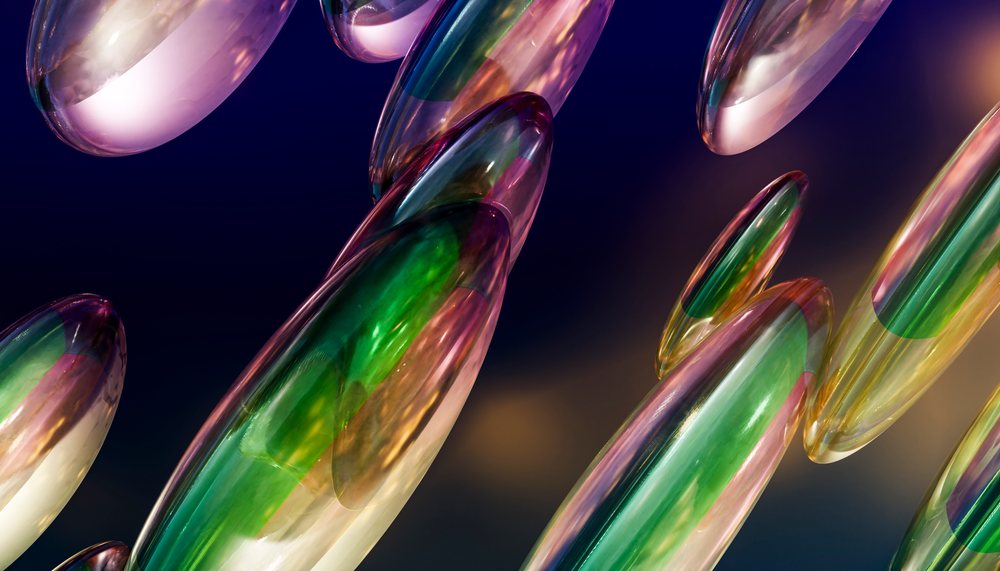 Colorful elongated glass capsules floating against a dark gradient background in an abstract artistic composition.