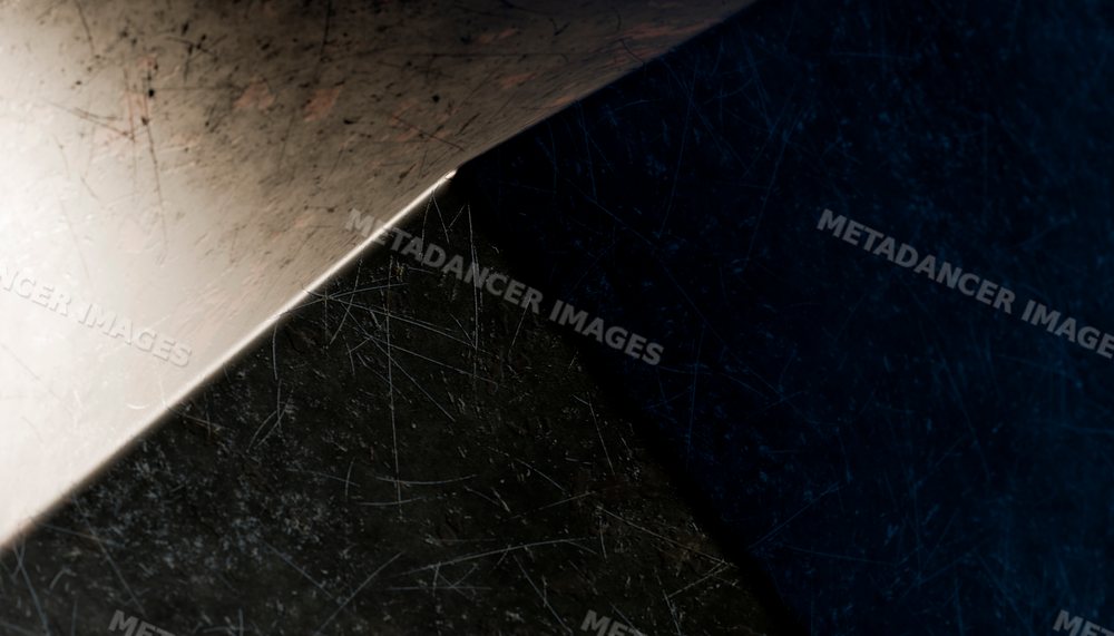 Close-up view of a scratched metal sheet corner with detailed texture