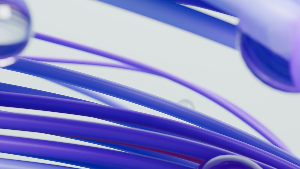 Abstract digital 3D illustration of smooth curved blue and purple tubes forming a dynamic flowing shape on a light background.